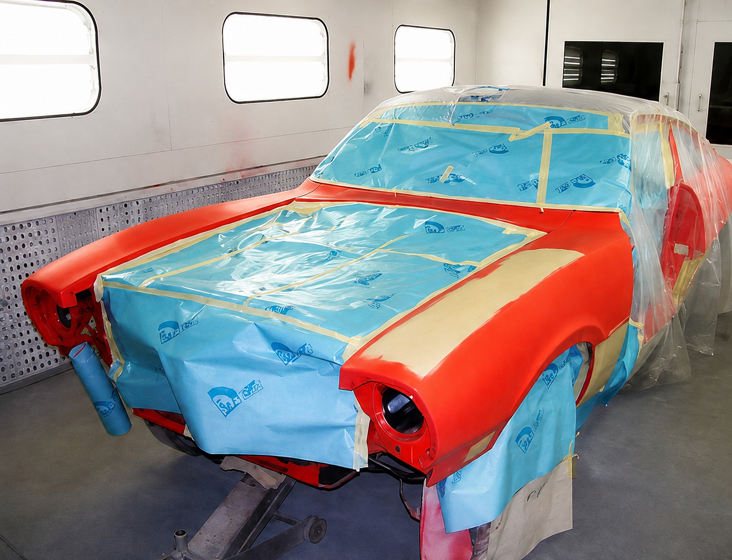 Vehicle masked and prepped inside Fenton's paint booth for color-matched refinishing