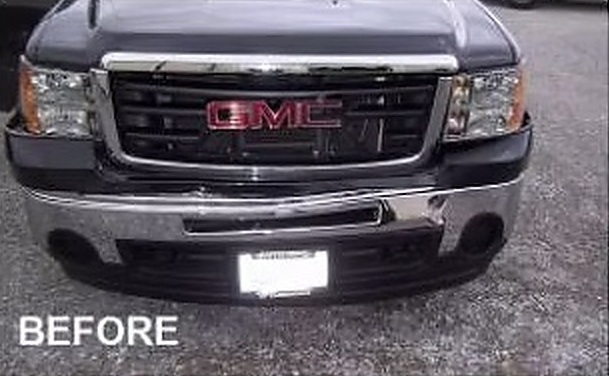 Before: front bumper and grille damage on a black GMC Sierra 1500