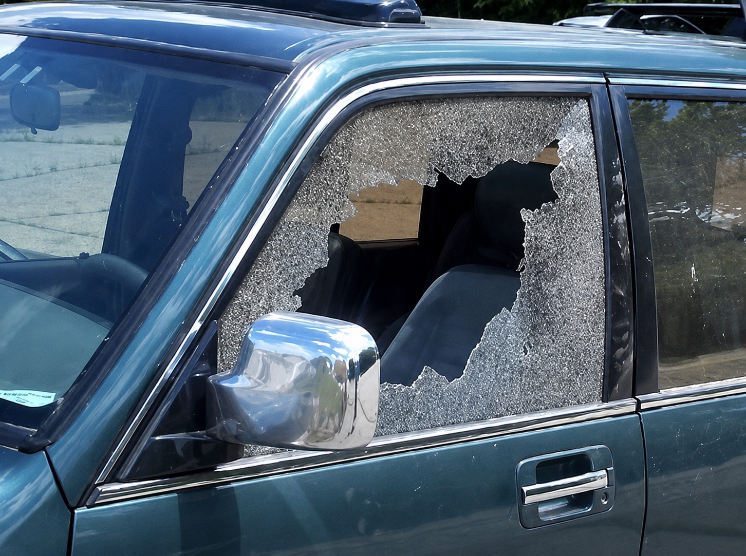 Cracked vehicle window glass — the kind of damage Fenton's repairs in-house